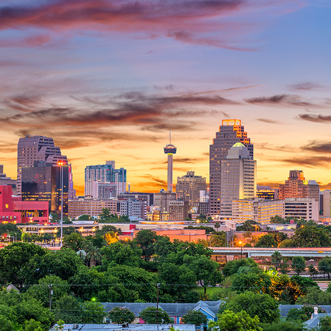 The San Antonio, Texas city skyline with the Tower of the Americas featured prominently.