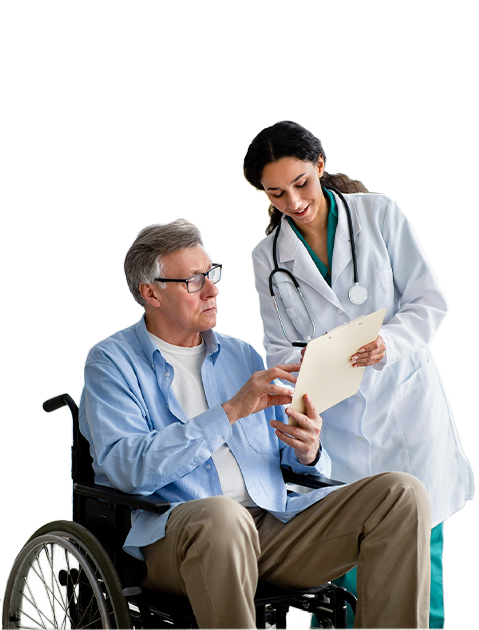 A doctor goes over test results on a clipboard with an elderly patient sitting in a wheelchair.